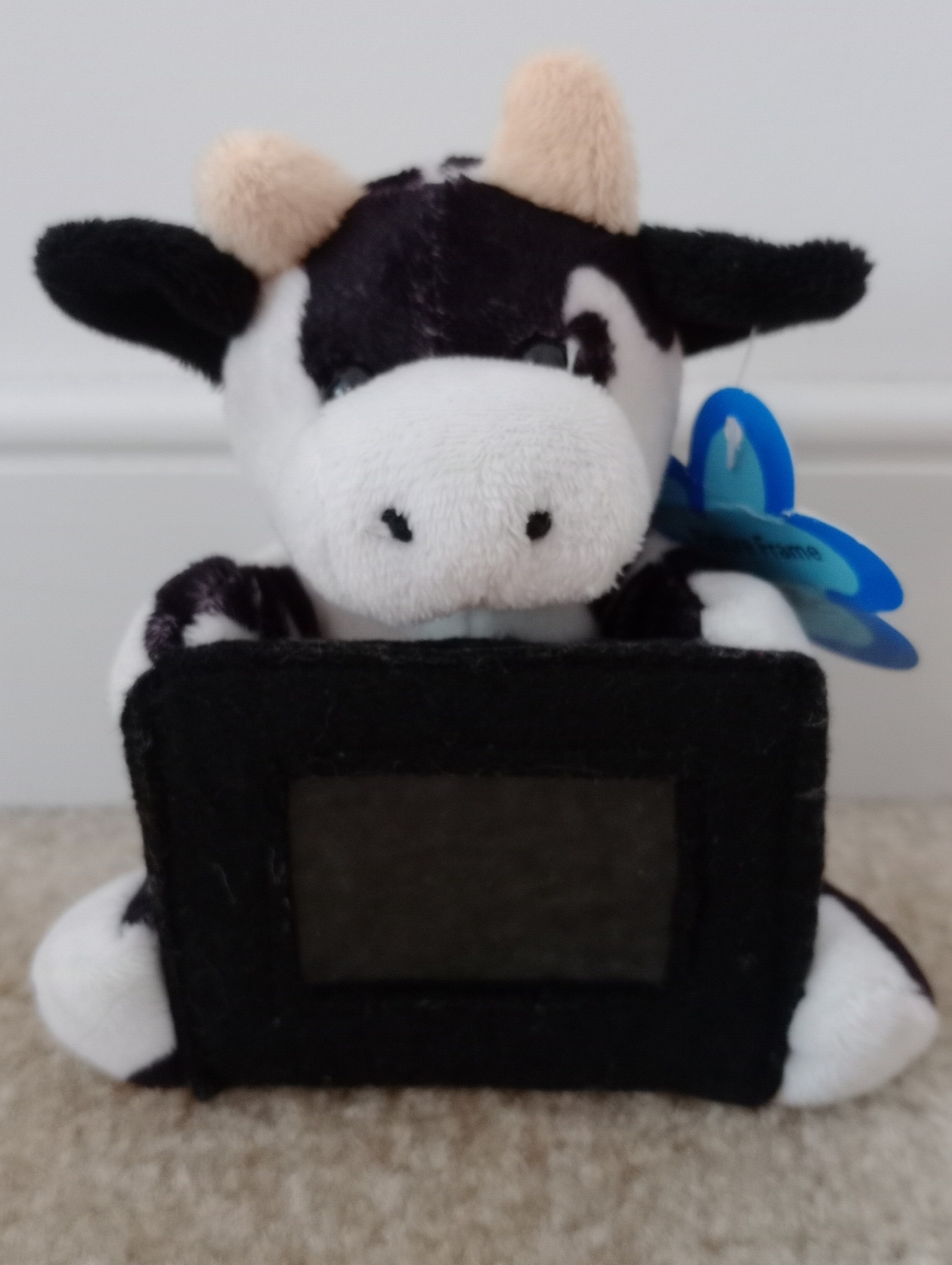Plush Black and White Cow Toy Holding A Picture Frame